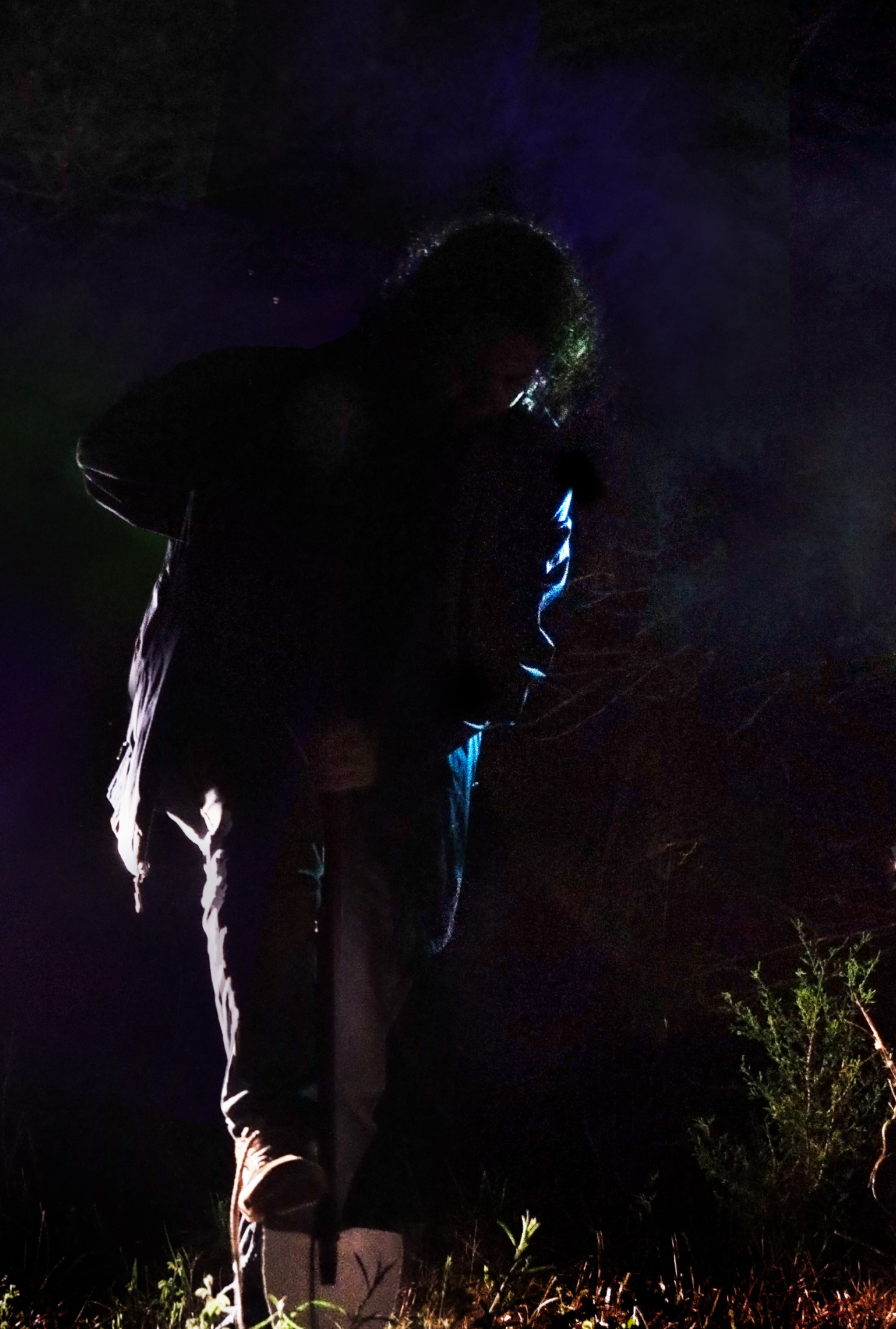 sillouette of a man digging with a shovel